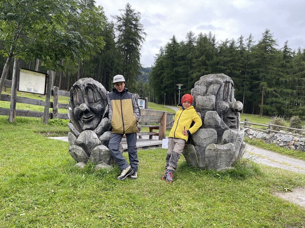sculture in legno a forma di pigne con viso
